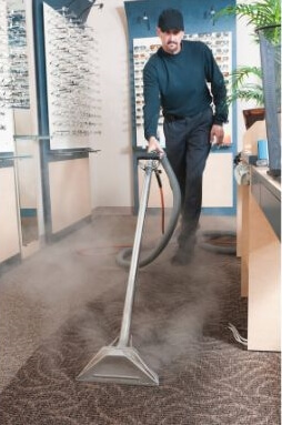 A man vacuuming an optical shop
