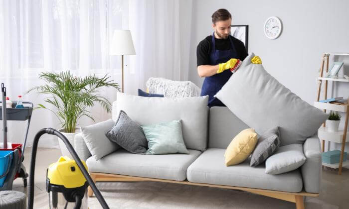 Man cleaning the sofa