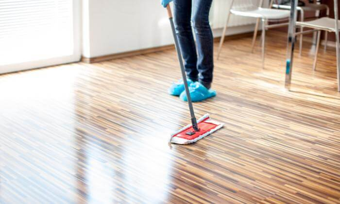 Washing wooden floors with a mop