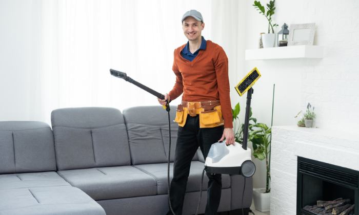 Man with an extraction vacuum cleaner