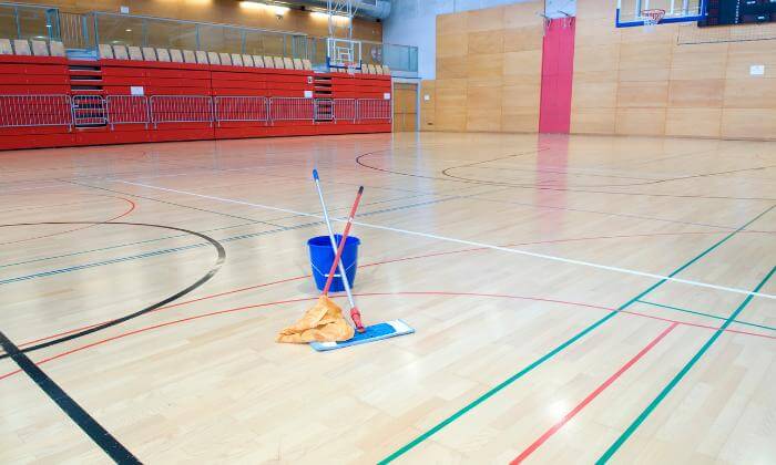 Washing the parquet floor of a sports hall